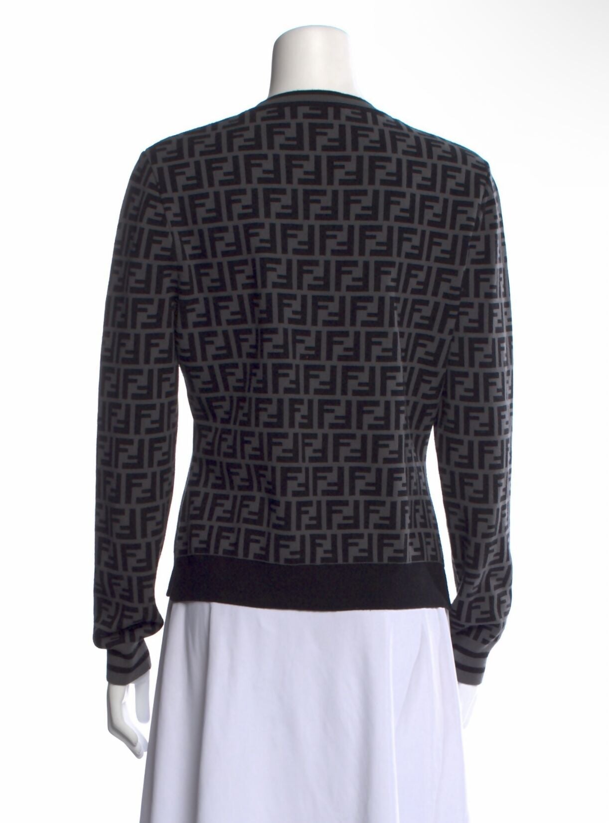 A mannequin models the EXCHANGE Fendi Grey/Black Monogram Knit Pullover (best fit 8-10/size 40) with a white skirt, displaying the back view.