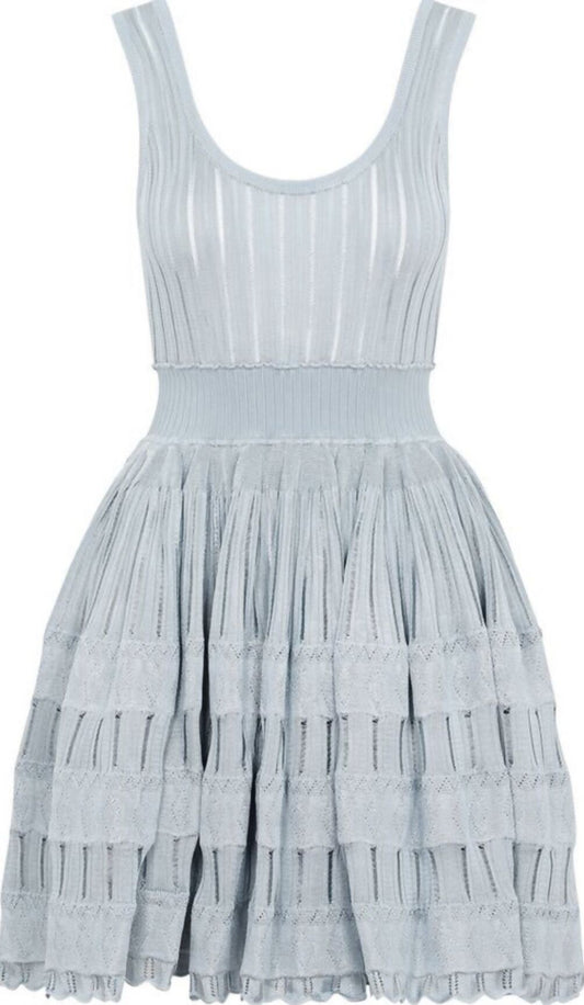 Brand new and unworn, the Alaia Fluid Skater Dress by EXCHANGE is light blue, sleeveless, with a fitted ribbed bodice and a flared tiered skirt featuring textured stripes and ruffle details. Includes original hanger.