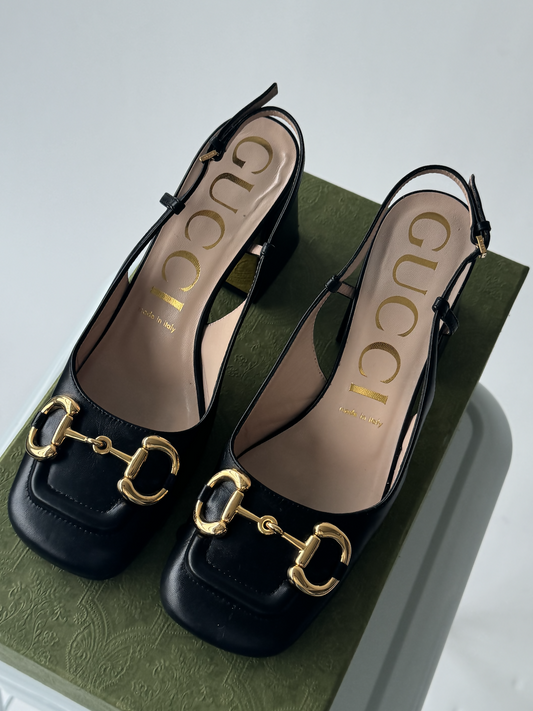The Gucci Horsebit Mid-Heel Slingback Pumps - Full Set by EXCHANGE are black slingback heels with gold horsebit details, shown on the original box and include dustbags.