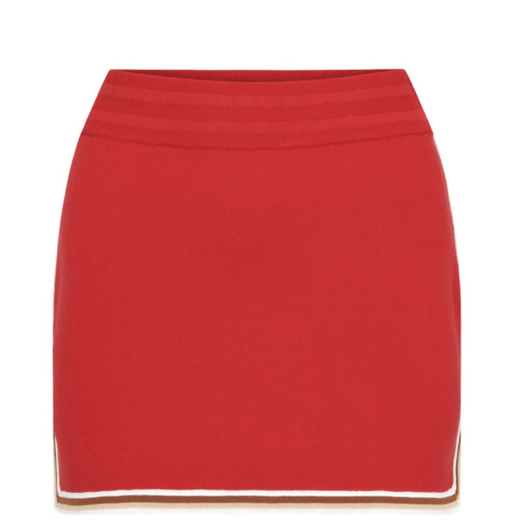 The EXCHANGE NAGNATA Motley Skirt in red, size XS, features a ribbed waistband, white and tan trim at the hem, side slits, and is shown on a plain white background.