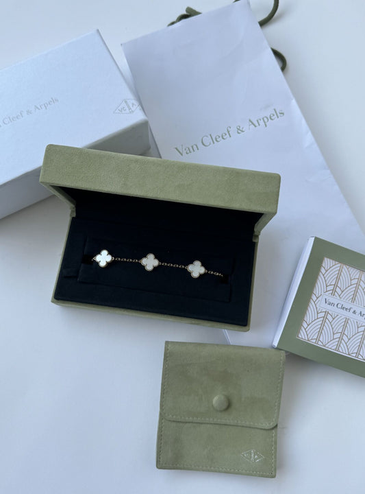 A Van Cleef & Arpels Alhambra bracelet, 5 motifs—FULL SET by EXCHANGE—is beautifully displayed in a green velvet box with branded packaging: white shopping bag, box, booklet, and small green suede pouch.
