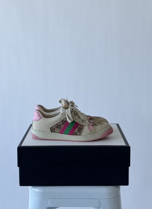 A Gucci Women's Screener Off White And Pink Sneaker by EXCHANGE, size 39, in fair condition sits on its original box atop a white stool against a plain light background.