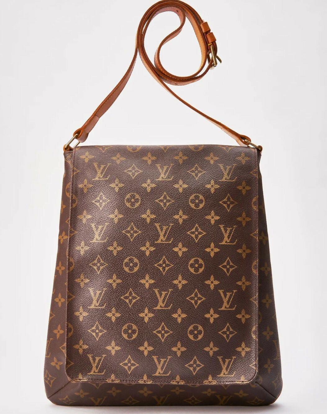 A Louis Vuitton Monogram Musette crossbody bag, authenticated by EXCHANGE, features the classic LV monogram, floral patterns, tan leather strap, and gold-tone hardware—shown on a plain white background.