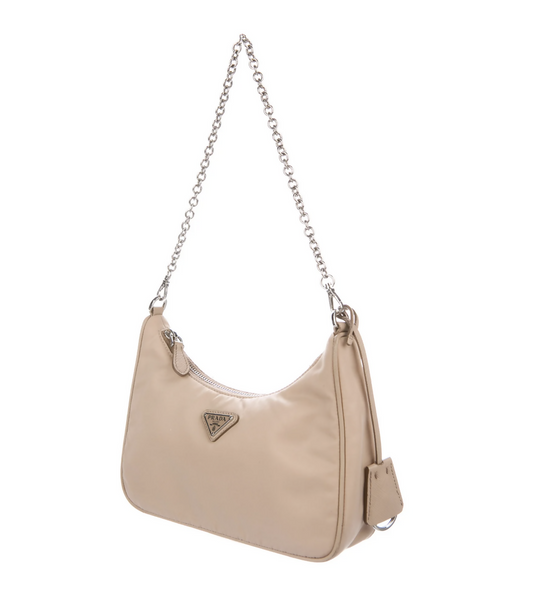 The PRADA 2019 Re-Edition 2005 Tessuto Mini Bag by EXCHANGE is a beige nylon hobo bag with a silver chain strap, front triangular Prada logo, attached pouch, and a sleek minimalist design. Comes as a full set.