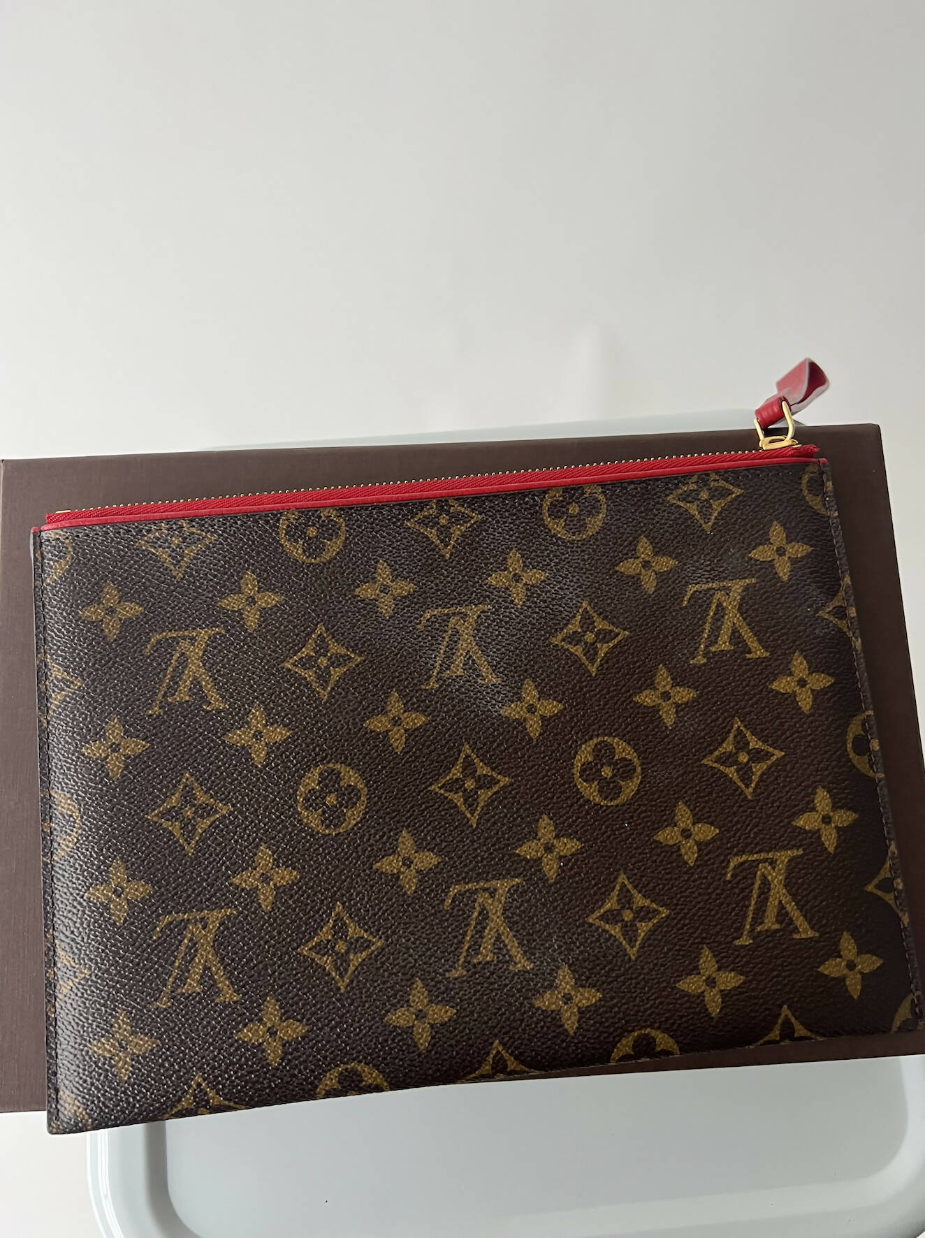 A Louis Vuitton Bicolor Monogram Pallas Pochette by EXCHANGE, featuring classic brown monogram canvas, gold LV logo accents, floral details, and a red zipper with gold pull. Includes box, dustbag, and receipts.
