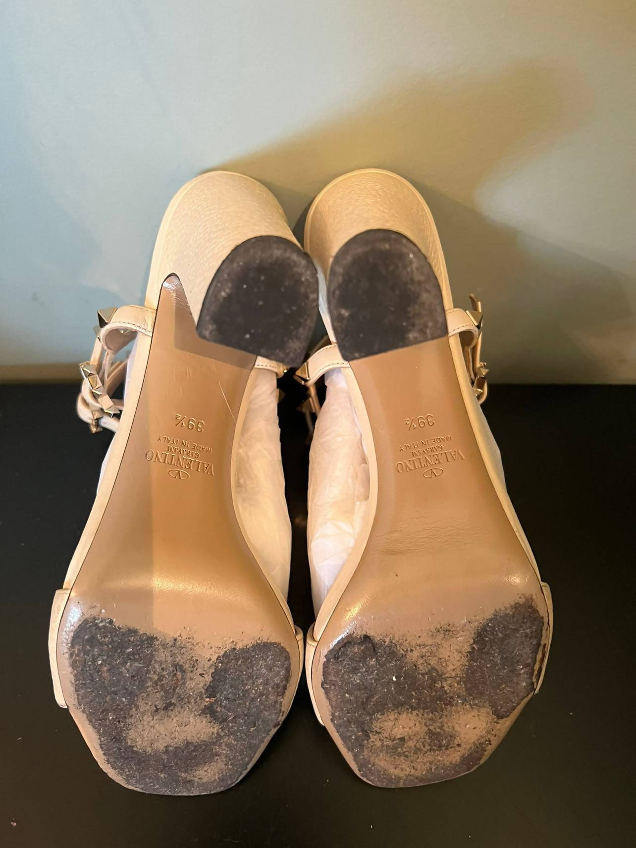 A pair of EXCHANGE Rock Studded Sandal - Ankle Strap Platform heels in beige, size 39.5, shown from the soles with visible wear and scuffing; features black heel tips and iconic studded sandal details.