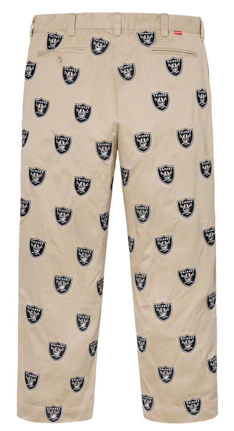 EXCHANGE Supreme NFL x Raiders x '47 Embroidered Chino Pant in beige khaki, Size L, with all-over black and white Raiders logo print, belt loops, pockets, and a relaxed fit—an exclusive collaboration standout.