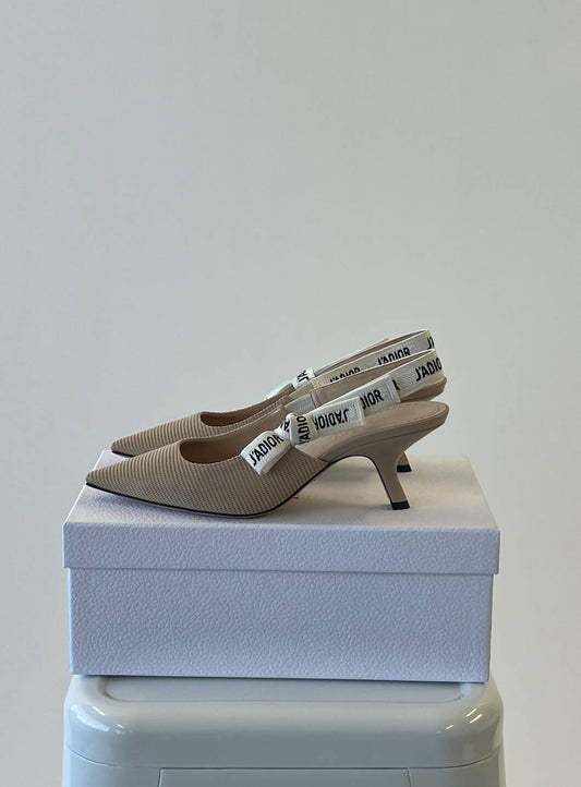 A pair of EXCHANGE Dior Sling Backs Fabric & Ribbon, size 42, in powder nude with kitten heels, pointed toes, and white J’Adior-printed straps shown on a white textured box against a plain background.