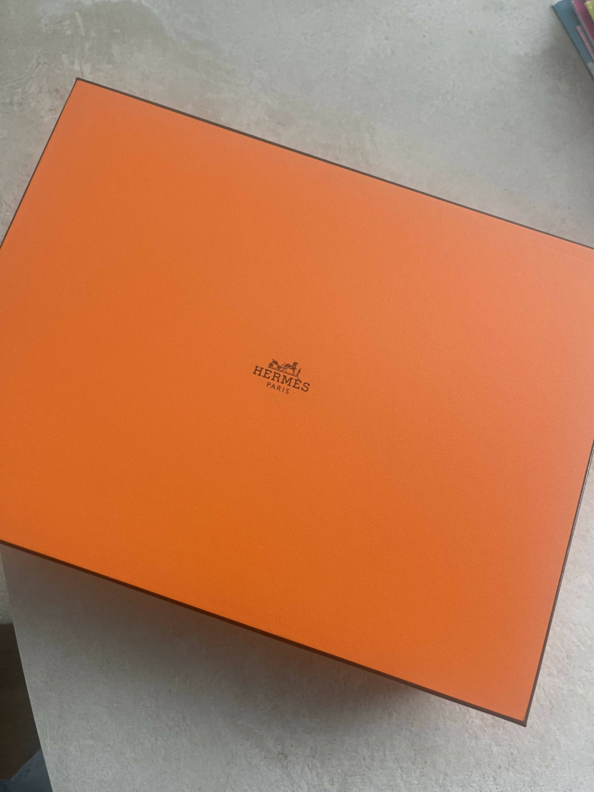 A branded orange EXCHANGE box sits on a light surface, containing a new Hermès Eze 30 Sandal - Full Set in size 39.