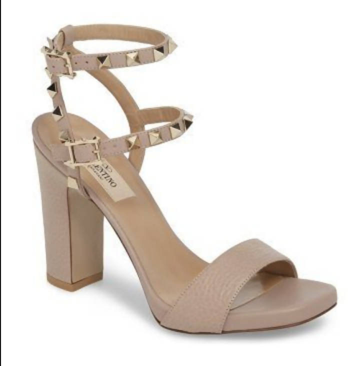 The EXCHANGE Rock Studded Sandal - Ankle Strap Platform 39.5 in beige features a block heel, open toe, single front strap, and two ankle straps with gold pyramid studs and buckles.