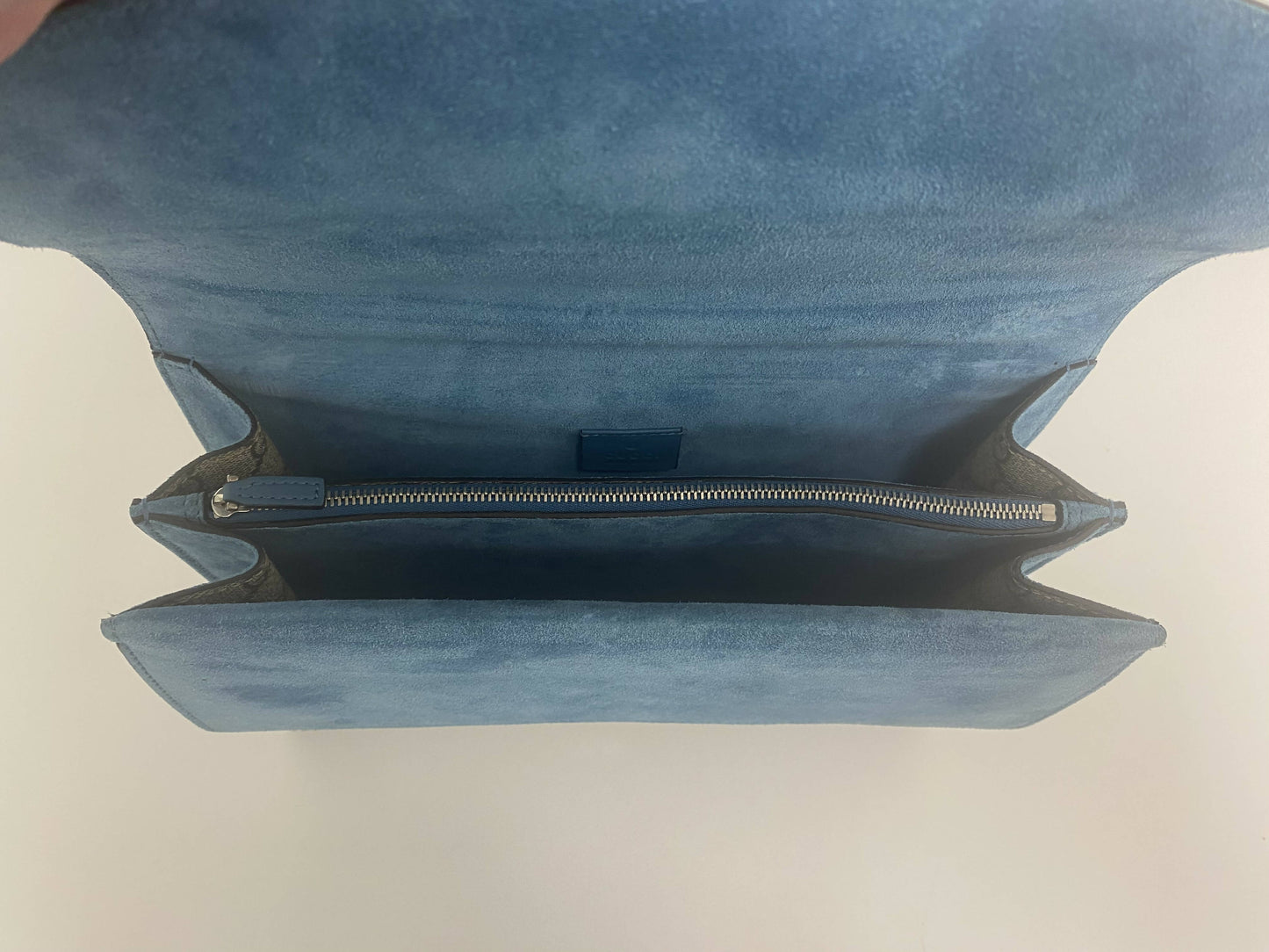 The Dionysus Embroidered Tiger Medium Shoulder Bag by EXCHANGE, seen from above, features a hand-embroidered appliqué, a zippered middle compartment, and two open sections inside for added elegance.