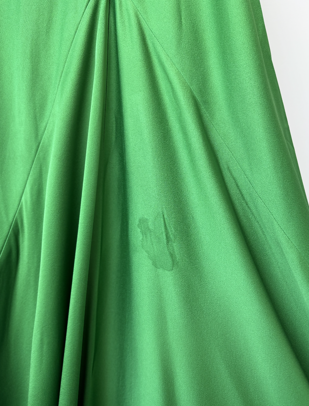 Victoria Beckham Resort 2022 Green Cami Slip Dress by EXCHANGE STORE, featuring a visible dark stain near the center and slight wrinkling and folds in the material.