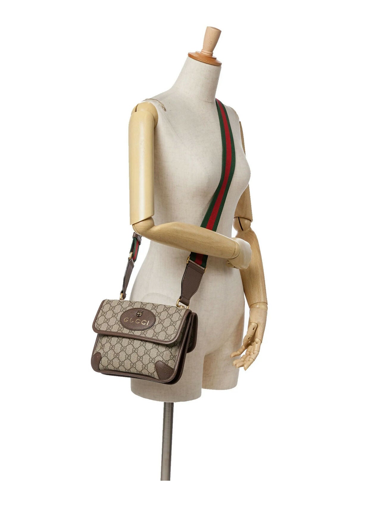 A mannequin displays an EXCHANGE STORE Gucci Neo Vintage messenger bag with GG monogram, leather trim, and a Web stripe strap against a plain white background.