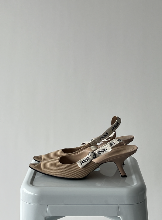 EXCHANGE Dior Sling Backs - Nude Fabric feature pointed toes and JADIOR branded white straps in beige, displayed on a light gray stool with a neutral background.